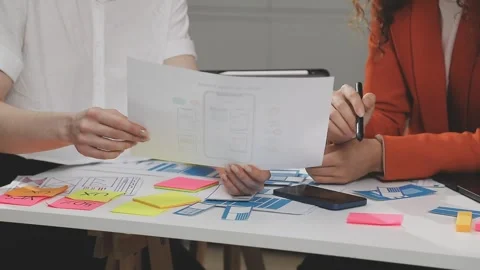 UX/UI designer working on wireframes for a website and mobile app prototype.. Stock Footage 309837667