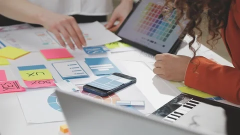 UX/UI designer working on wireframes for a website and mobile app prototype.. Stock Footage 309837688
