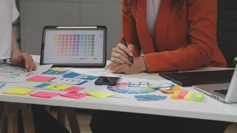 UX/UI designer working on wireframes for a website and mobile app prototype.. Stock Footage 309837700