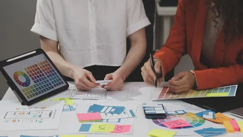 UX/UI designer working on wireframes for a website and mobile app prototype.. Stock Footage 309837714