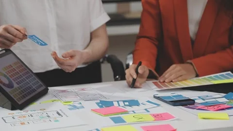 UX/UI designer working on wireframes for a website and mobile app prototype.. Stock Footage 309837732