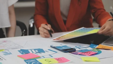 UX/UI designer working on wireframes for a website and mobile app prototype.. Stock Footage 309837739