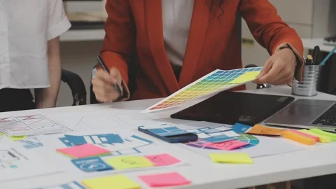 UX/UI designer working on wireframes for a website and mobile app prototype.. Stock Footage 309837740