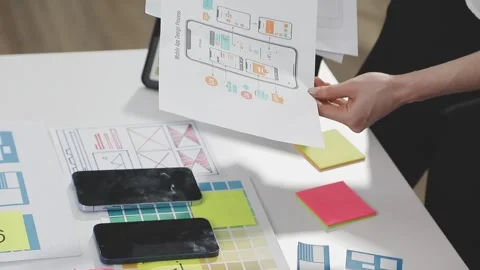 UX/UI designer working on wireframes for a website and mobile app prototype.. Stock Footage 309837774