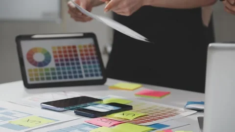 UX/UI designer working on wireframes for a website and mobile app prototype.. Stock Footage 309837775