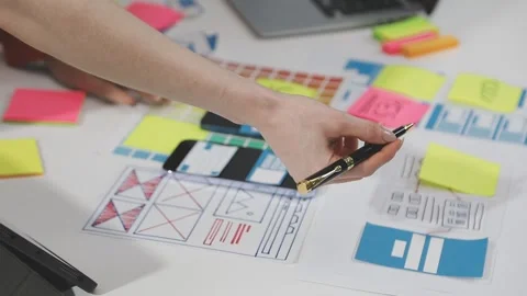 UX/UI designer working on wireframes for a website and mobile app prototype.. Stock Footage 309837786