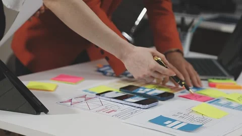 UX/UI designer working on wireframes for a website and mobile app prototype.. Stock Footage 309837792