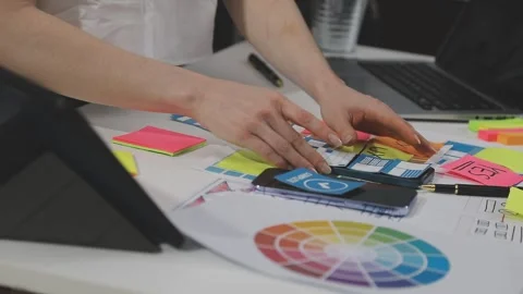 UX/UI designer working on wireframes for a website and mobile app prototype.. Stock Footage 309837817