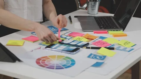 UX/UI designer working on wireframes for a website and mobile app prototype.. Stock Footage 309837827