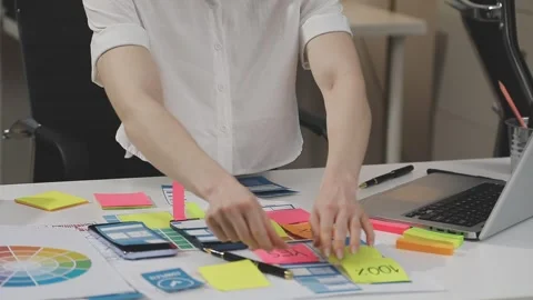 UX/UI designer working on wireframes for a website and mobile app prototype.. Stock Footage 309837834