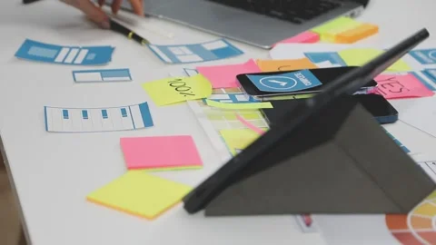 UX/UI designer working on wireframes for a website and mobile app prototype.. Stock Footage 309837837