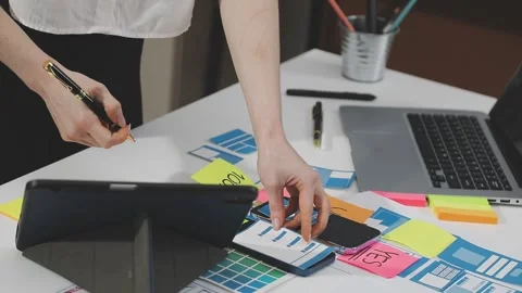 UX/UI designer working on wireframes for a website and mobile app prototype.. Stock Footage 309837862