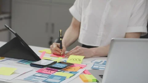 UX/UI designer working on wireframes for a website and mobile app prototype.. Stock Footage 309837895
