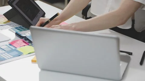 UX/UI designer working on wireframes for a website and mobile app prototype.. Stock Footage 309837899