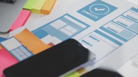UX/UI designer working on wireframes for a website and mobile app prototype.. Stock Footage 309838255
