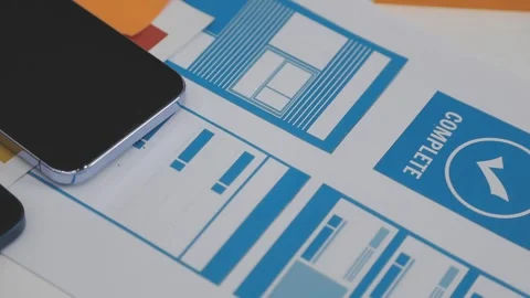 UX/UI designer working on wireframes for a website and mobile app prototype.. Stock Footage 309838256