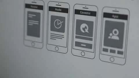 UX/UI designer working on wireframes for a website and mobile app prototype.. Stock Footage 309838279