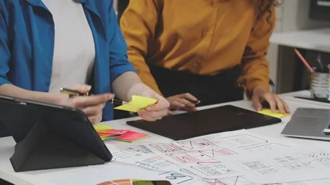 UX/UI designer working on wireframes for a website and mobile app prototype.. Stock Footage 309838328