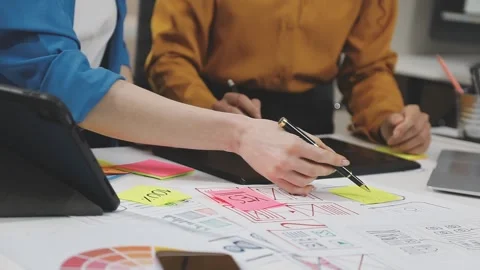 UX/UI designer working on wireframes for a website and mobile app prototype.. Stock Footage 309838341