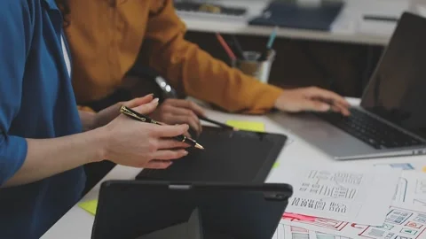 UX/UI designer working on wireframes for a website and mobile app prototype.. Stock Footage 309838346