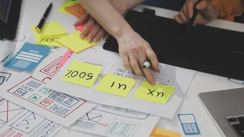 UX/UI designer working on wireframes for a website and mobile app prototype.. Stock Footage 309838348