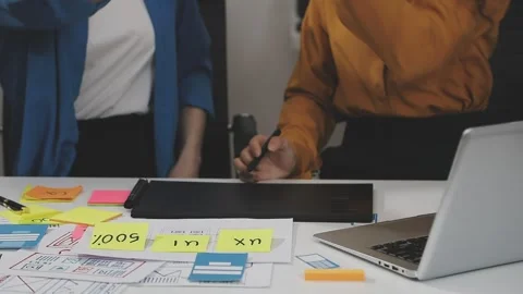 UX/UI designer working on wireframes for a website and mobile app prototype.. Stock Footage 309838350