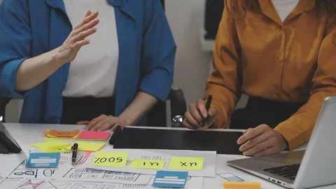 UX/UI designer working on wireframes for a website and mobile app prototype.. Stock Footage 309838351