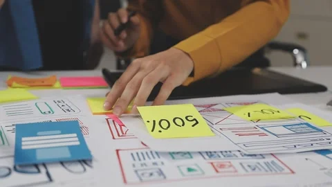UX/UI designer working on wireframes for a website and mobile app prototype.. Stock Footage 309838352