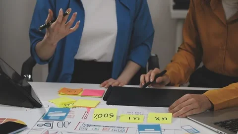 UX/UI designer working on wireframes for a website and mobile app prototype.. Stock Footage 309838353