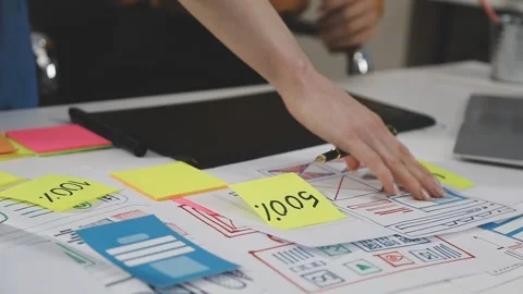 UX/UI designer working on wireframes for a website and mobile app prototype.. Stock Footage 309838354