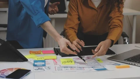 UX/UI designer working on wireframes for a website and mobile app prototype.. Stock Footage 309838356