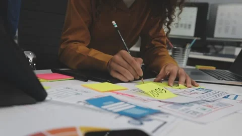 UX/UI designer working on wireframes for a website and mobile app prototype.. Stock Footage 309838357
