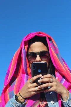 UYUNI, BOLIVIA - May 01, 2019: Woman using a cellphone Stock Photos