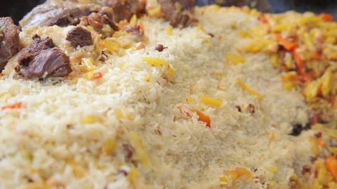 Uzbek pilaf on a cauldron Stock Footage 137442662