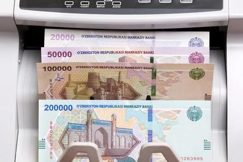 Uzbekistani sum in the counting machine Stock Photos