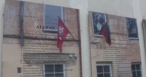 Uzupis Republic constitution plaques with flags reflected on old wall Video stock 321048400