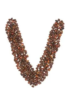 V letter made of cedar  nuts Stock Photos