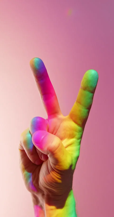 V Peace Gesture in Rainbow Light over Pink Background in slow motion Stock Footage 347957695