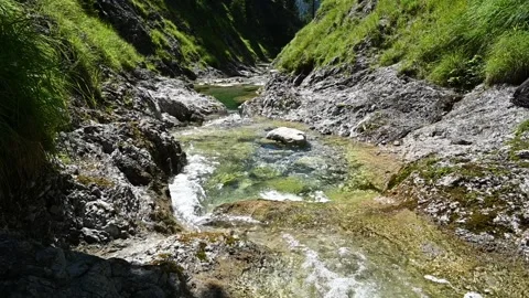 V-shaped mountain stream in summer with grass on the sides (slow motion) Stock Footage 260842759