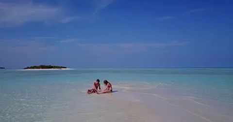 V04015 Aerial flying drone view of Maldives white sandy beach 2 people young Stock Footage