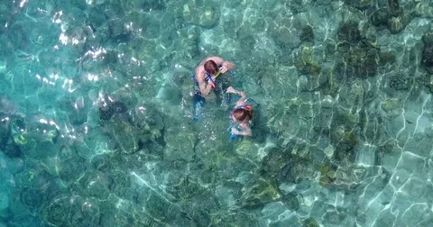 V04075 Aerial flying drone view of Maldives white sandy beach 2 people young Stock Footage