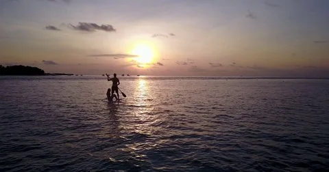 V04083 Aerial flying drone view of Maldives white sandy beach 2 people young Stock Footage
