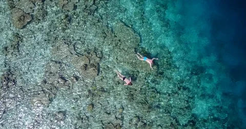 V06466 Aerial flying drone view of Maldives white sandy beach young people Stock Footage