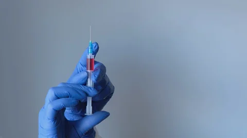 V1-0026 DSCF5369close-up of a nurse's hand with a syringe releases air, prepares Stock Footage 129496232
