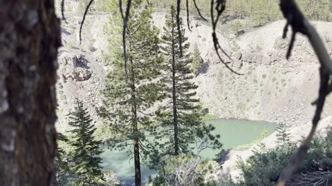 V1-0054 Pull Back From Crate Lake With Tree In The Foreground Stock Footage 245839786