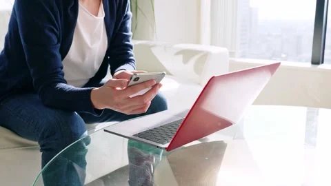 V1-0056 sWoman using a smart phone and a laptop pc in office. Slow motion. Stock Footage 149719549