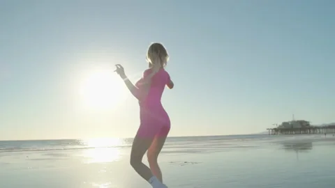 V2-0202 Blonde gets high at sunset on the beach by the ocean in a pink top a Stock Footage 170157640
