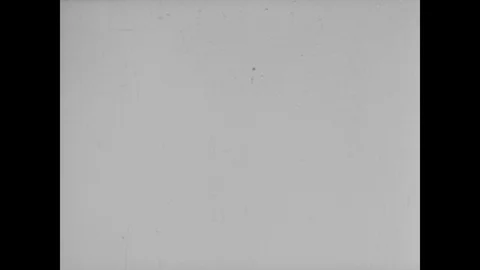 V2 rocket lands in the ocean with parachute before being fished out by workmen Stock Footage 103385487