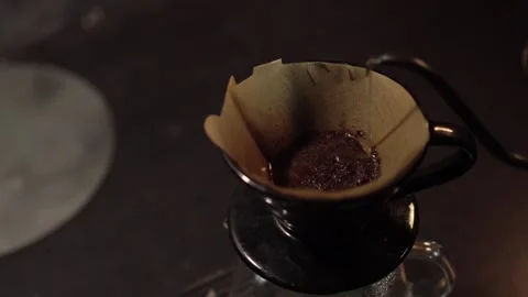 V60 Coffee Blooming Process with Hot Water. Hot water is gently poured onto.. Stock Footage 306294897