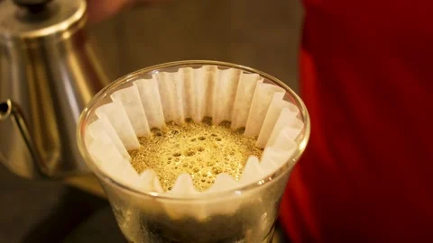 V60 Paper Filter with Blooming Coffee Grounds on Glass Carafe, Third Wave Stock Footage 336178175